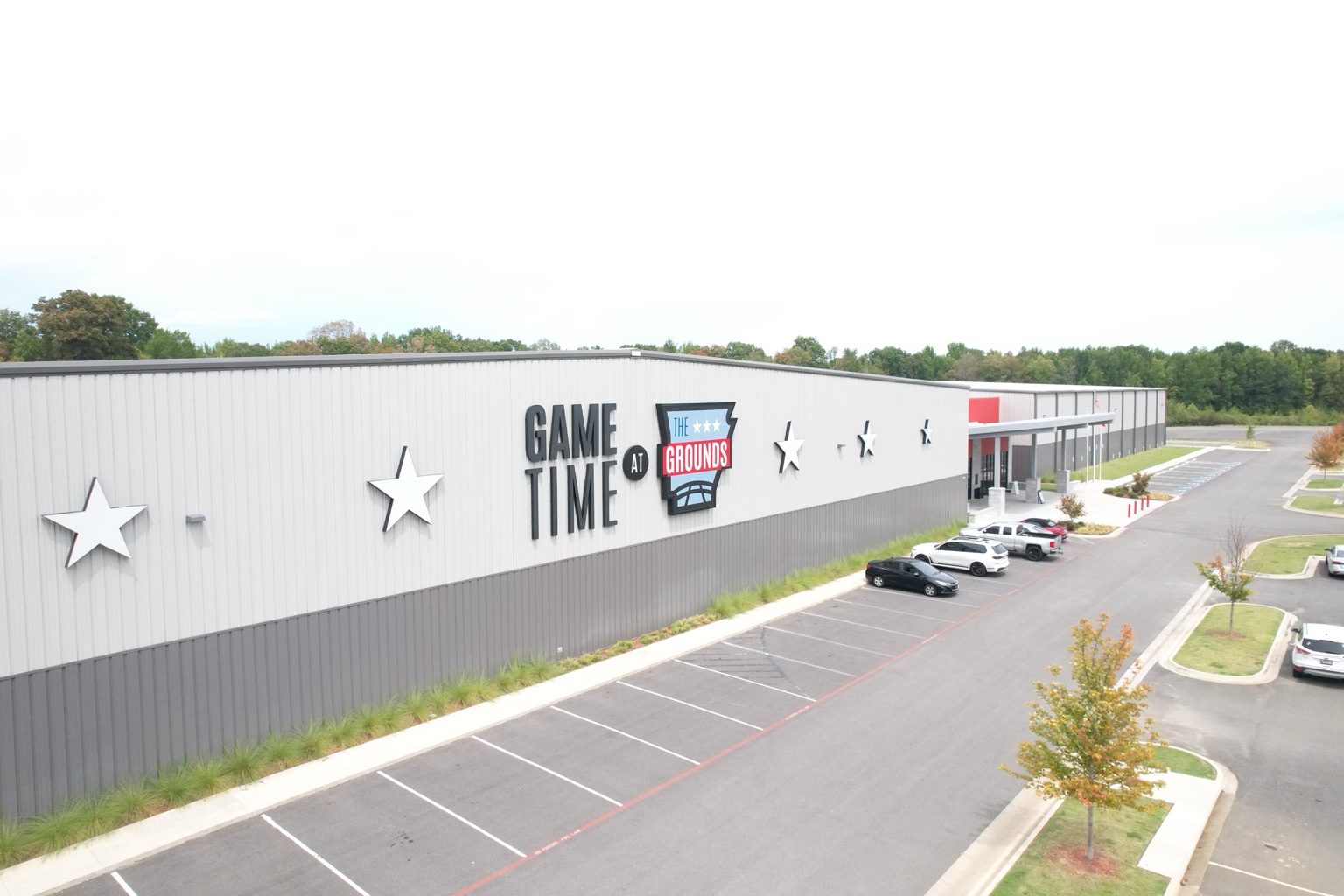 Aerial side elevation showing Game Time at The Grounds branding and parking access
