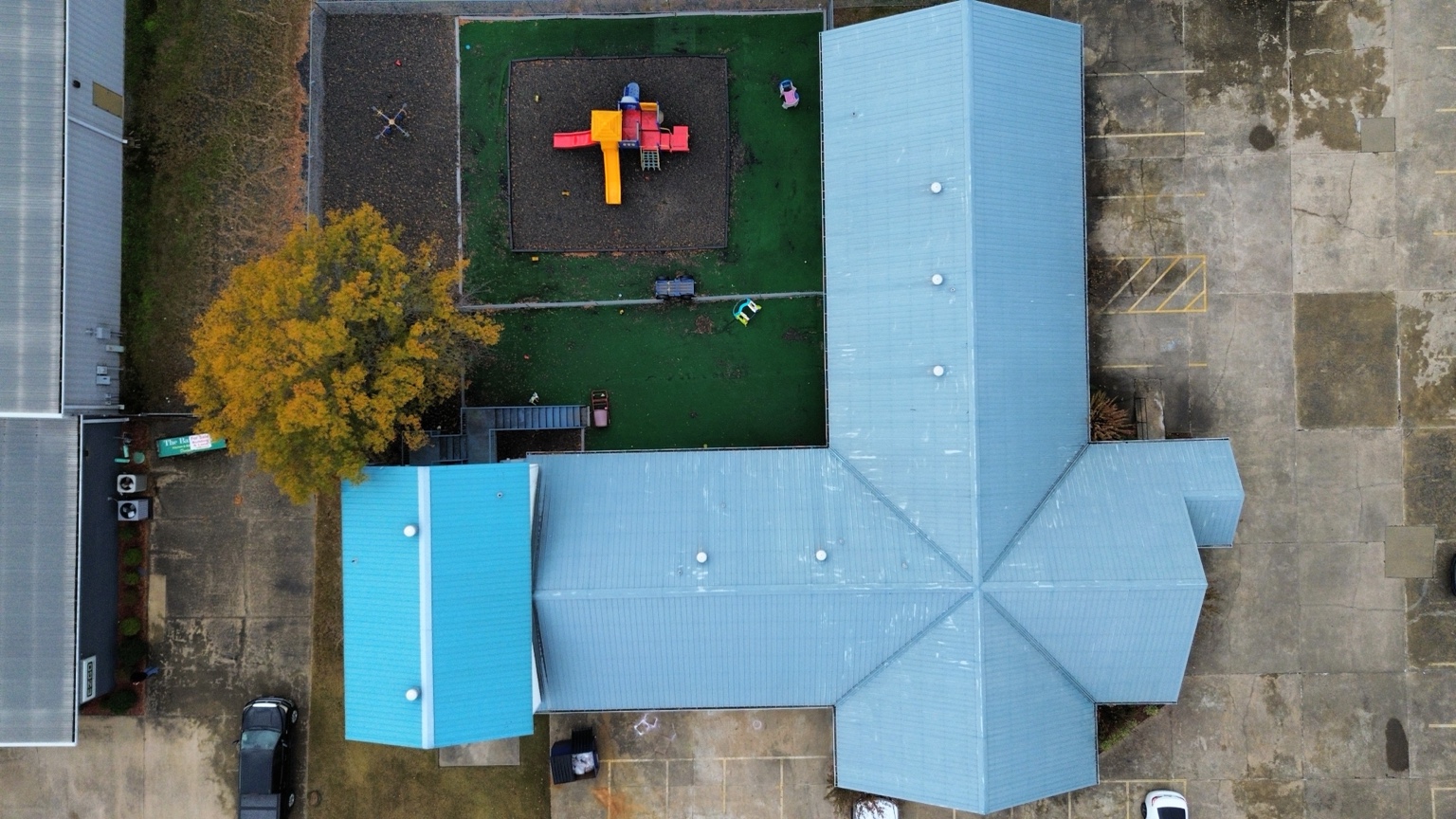 Straight-down drone inspection view of a large metal roof