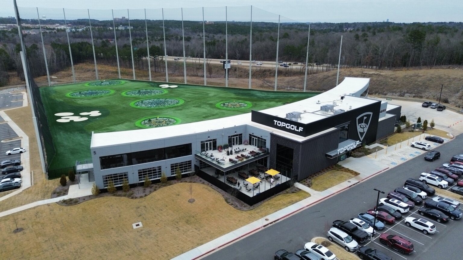 Wide aerial view of the complete Topgolf property